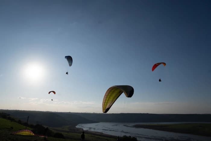 Paraglider in flight over the Moroccan desert