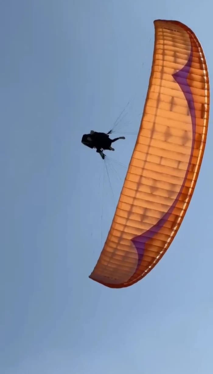 Paraglider silhouetted against the sunset sky in Marrakech